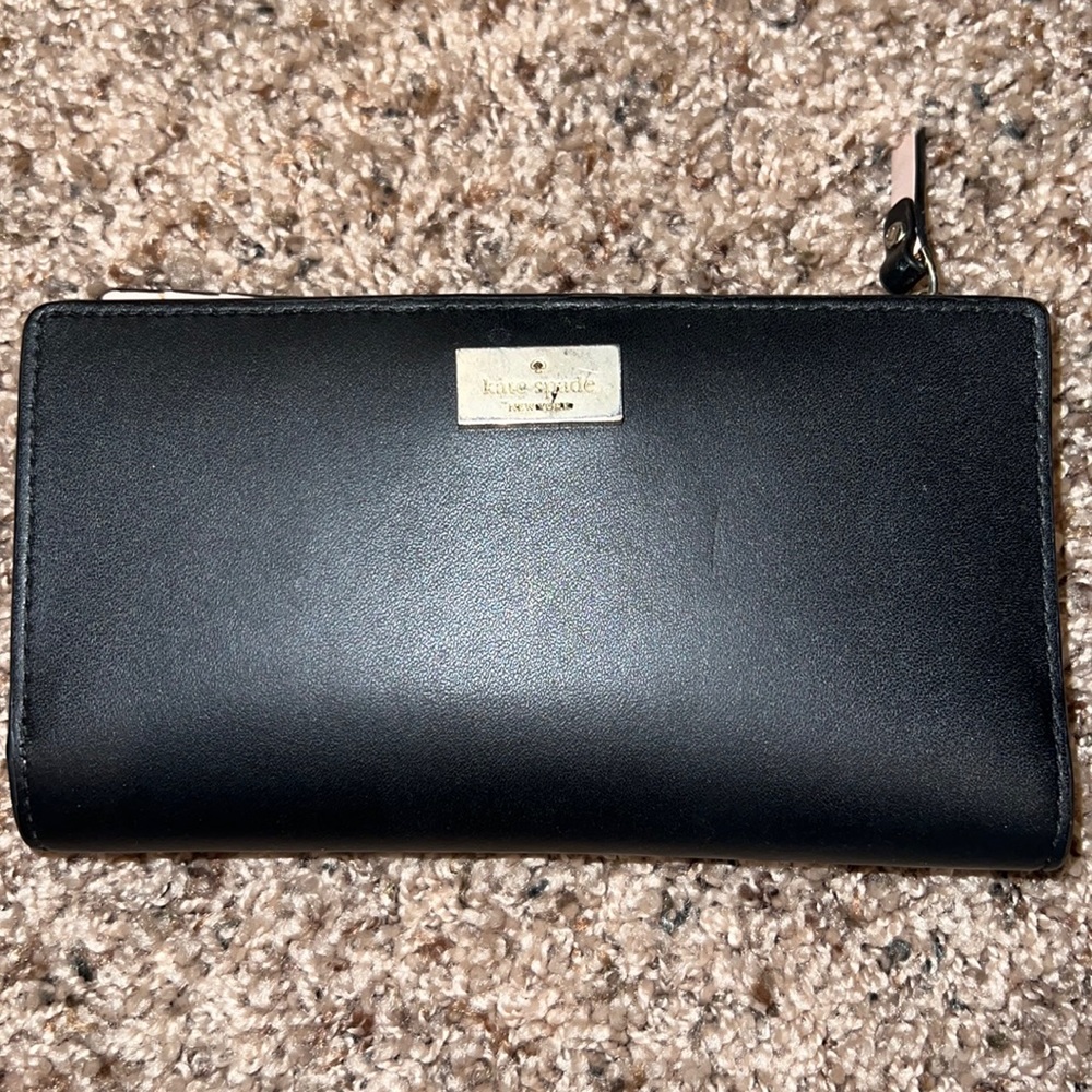 Kate Spade black wallet with pink interior. Very versatile